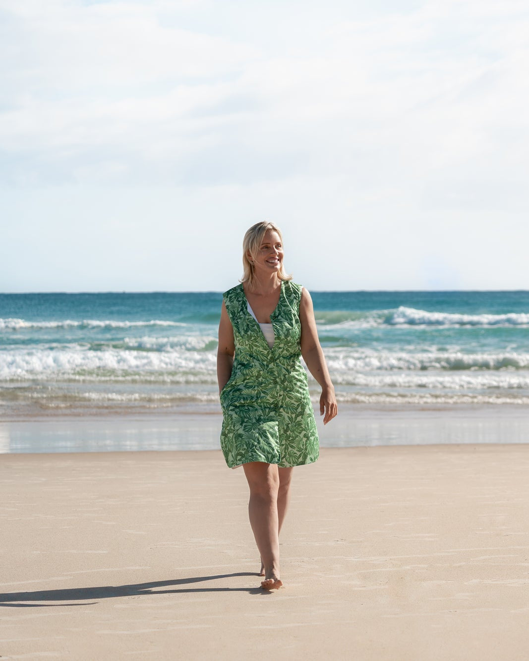 Neren Signature After-Swim Dress in Canopy worn walking beside the shoreline