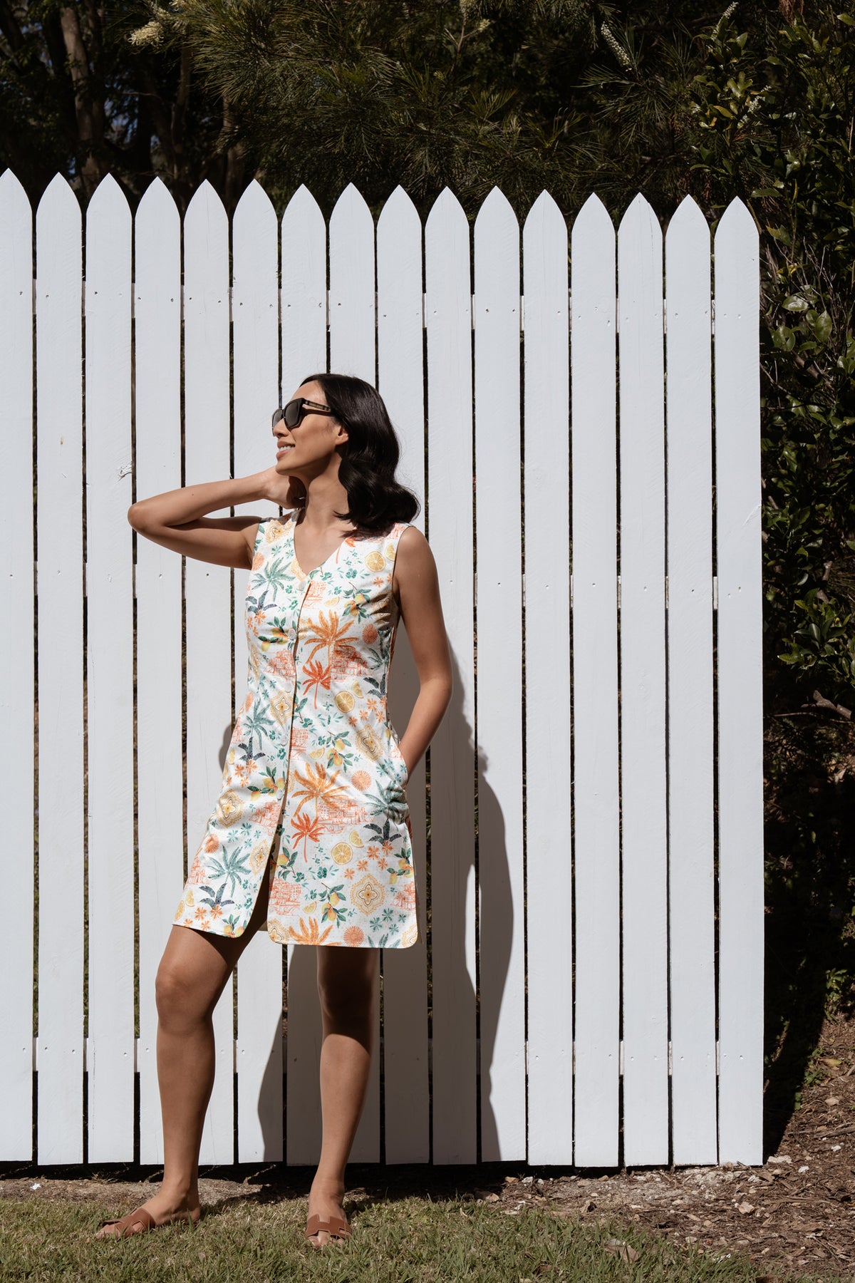 Woman in the Neren Signature After-Swim Dress in Valencia standing in a garden